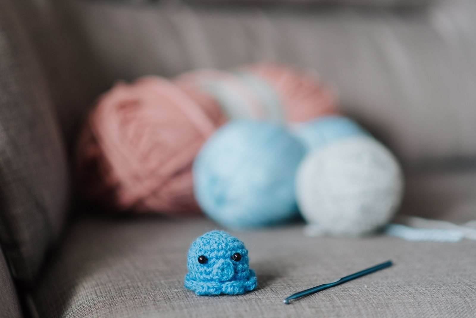 crochet as self-care scene with yarn, hook and amigurumi octopus