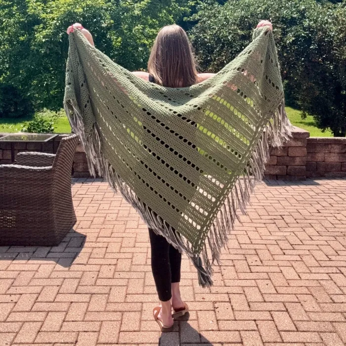woman wearing green crochet wrap outside
