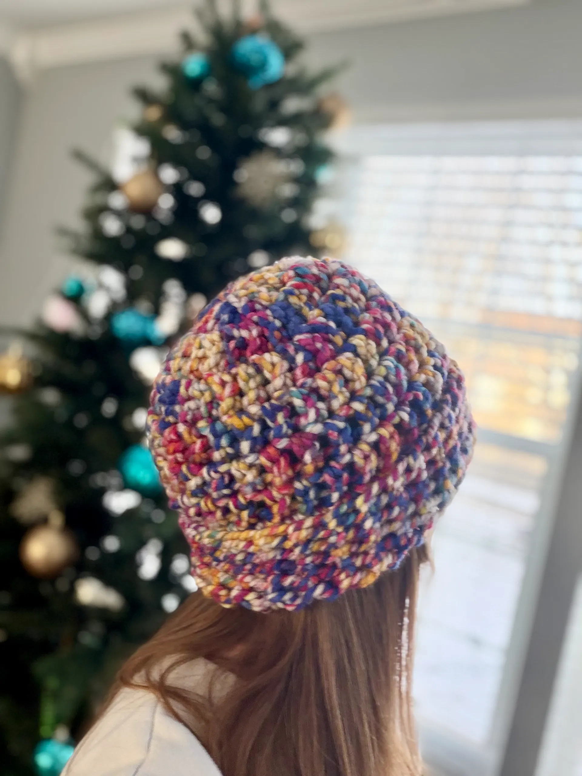 crochet stash buster beanie hat in multi-colors on a woman